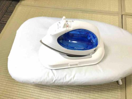 a white toilet with a blue bowl on top of it at Julian home Shinagawa 5 mins Shibuya 7 mins in Tokyo