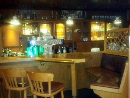 a bar with two chairs and a counter in a restaurant at Hotel-Restaurant Zum Stern in Baumholder