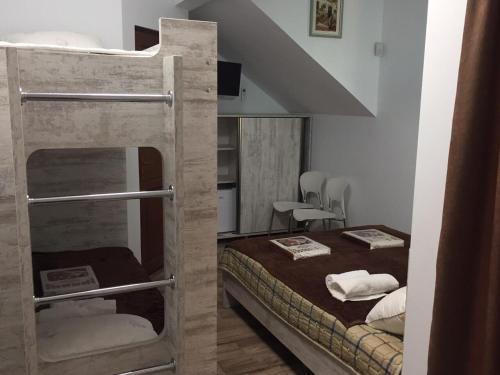a room with a bunk bed and a table and chairs at Cottage Euro Style in Ureki