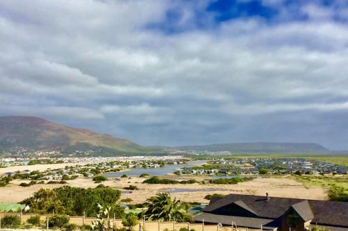 a view of a river with houses and a town at 365 Sunset Self Catering Apartments in Noordhoek