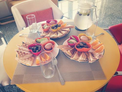 a yellow table with three plates of food on it at Full Moon Resort in Hengchun