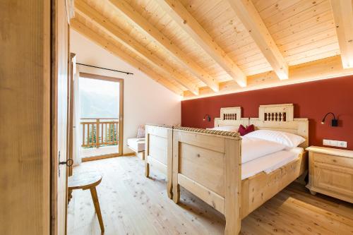 a bedroom with a large bed and a wooden ceiling at Hütterhof in Lagundo