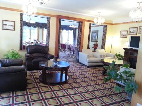 a living room with couches and a table at Granite Town Hotel in Saint George