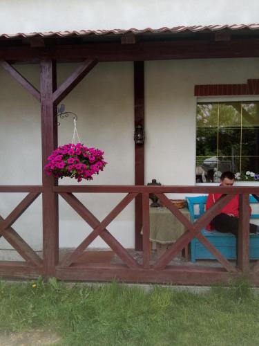 a wooden fence with a flower pot on it at Homestay Khomenko in Perechin