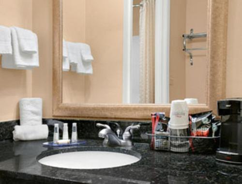 a bathroom with a sink and a mirror at Baymont by Wyndham Elkhart in Elkhart
