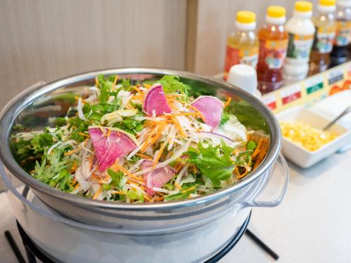 a salad in a pot on a stove at Super Hotel Fuji Inter in Fuji