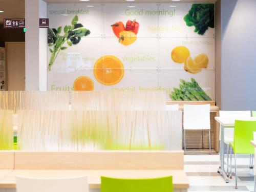 a large display of fruits and vegetables on a wall at Super Hotel Fuji Inter in Fuji