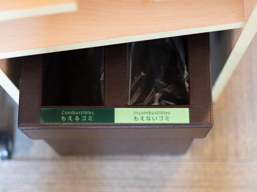 a box of wine sitting on a shelf at Super Hotel Fuji Inter in Fuji