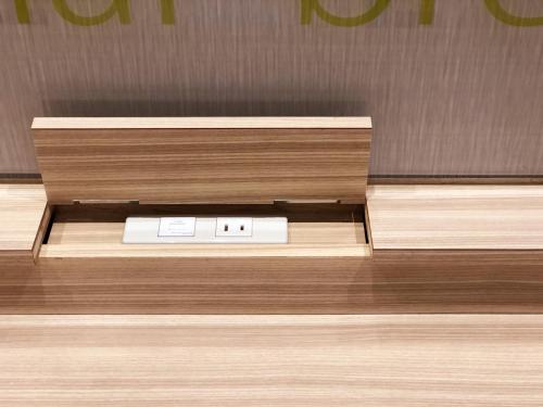 a clock on a wooden counter in a room at Super Hotel Fuji Inter in Fuji