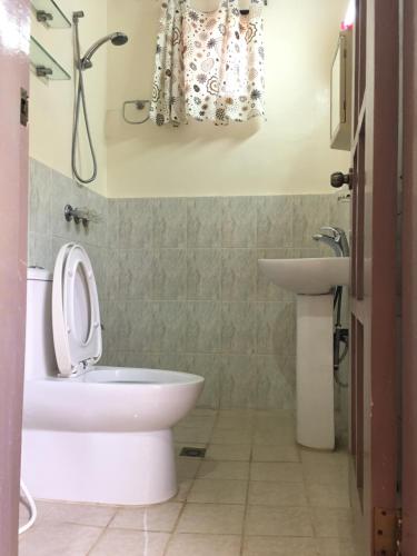a bathroom with a toilet and a sink at Eagles Nest Beach Resort in Davao City