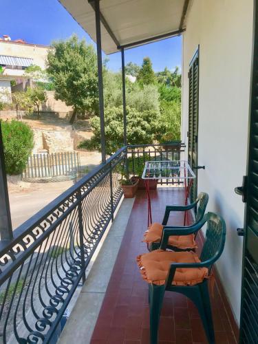 a balcony with two chairs sitting on a porch at Villa Elisa in Minturno
