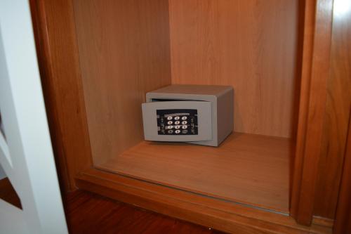 a microwave oven sitting inside of a wooden cabinet at Apartamento Edificio Plaza Gran Vía in Salamanca
