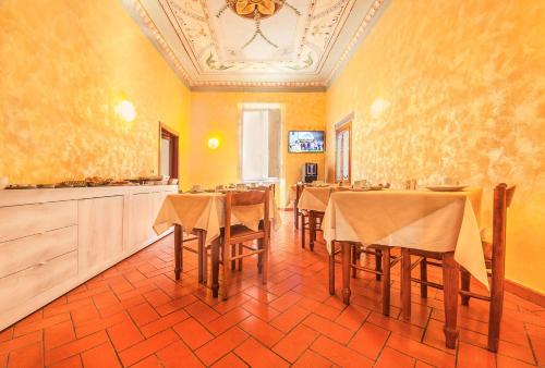 a large room with tables and chairs in it at Hotel Costantini in Florence