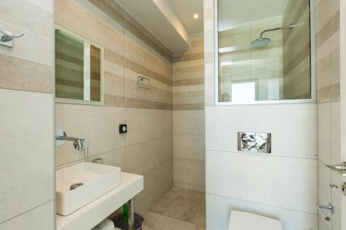 a bathroom with a sink and a mirror at Naiades Apartment- Minthi/ 1 bedroom, beachfront in Plakias