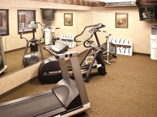 a gym with two exercise bikes and a treadmill at Kelly Inn and Suites Mitchell in Mitchell