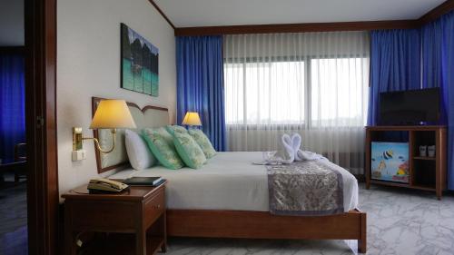 Cama o camas de una habitación en Wattana Park Hotel