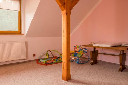 a room with a wooden pole and a table at Rodinný apartmán Rodvínov in Rodvínov