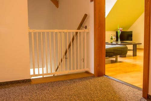 a door leading to a living room with a staircase at Rodinný apartmán Rodvínov in Rodvínov