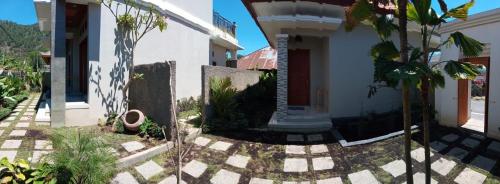 a house with a courtyard in front of it at The Villa's Kubu Sandan in Kintamani
