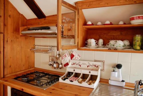 a kitchen with a stove and a stove top oven at CasAda in Nus