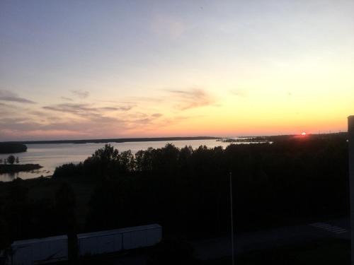 a sunset over a body of water at Two bedroom apartment Best view to the sea Glassed Balcony FREE PRIVATE PARKING in Kemi