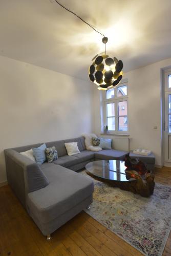 a living room with a couch and a coffee table at Kaiserliche Hofpost, mit Whirlpool und 2 Terrassen in Schleiden