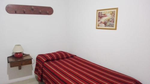 a bedroom with a red bed and a red blanket at Wine Aparts in Mendoza