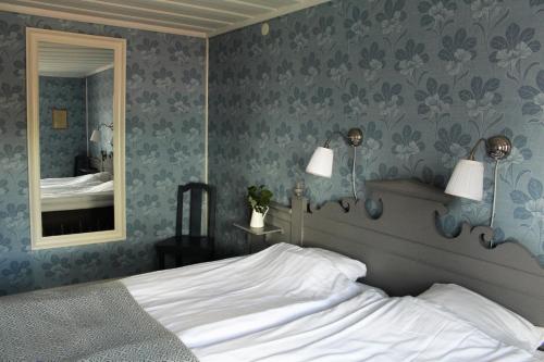 a bedroom with a bed and a mirror at STF Hostel Vilhelmina Kyrkstad in Vilhelmina