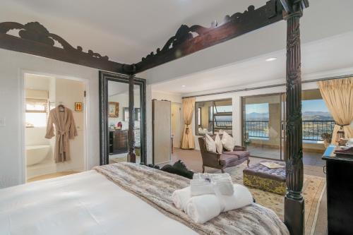 a bedroom with a large bed with a large mirror at Villa Castollini in Brenton-on-Sea