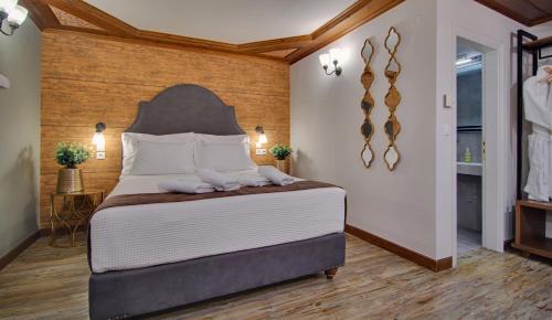 a bedroom with a large bed with two towels on it at Frontzu Politia in Ioannina
