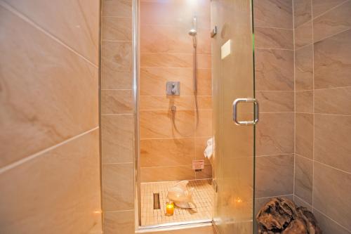 a shower with a glass door in a bathroom at Windermere Boutique Hotel Spa Suites & Hot Tubs in Windermere