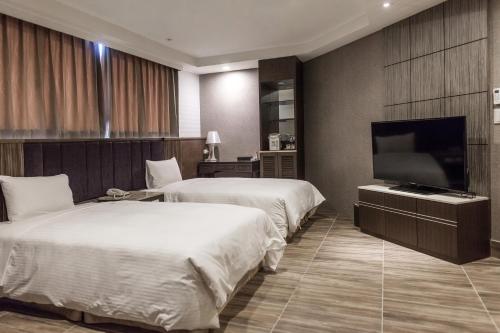 מיטה או מיטות בחדר ב-Maple Hotel Second Branch
