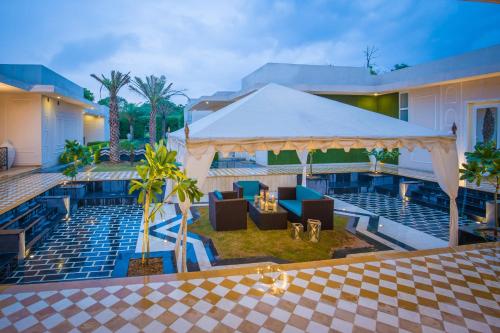 a view of a resort with chairs and a pavilion at Rose Amer in Jaipur