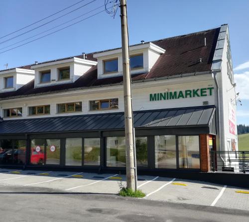 a building with a minnesota market sign on it at Apartman Ema in Donovaly