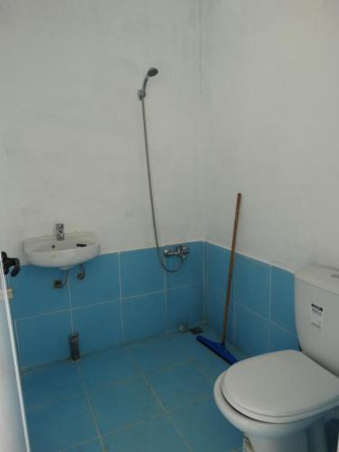 a bathroom with a toilet and a sink at AliBaba Apartment Hostel Bamboo Rooftop Room in Chefchaouen