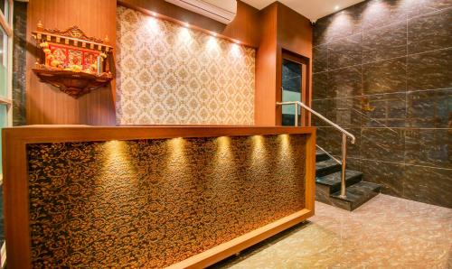 a bathroom with a swimming pool in a room with a shower at Treebo Arvind Residency in Mumbai