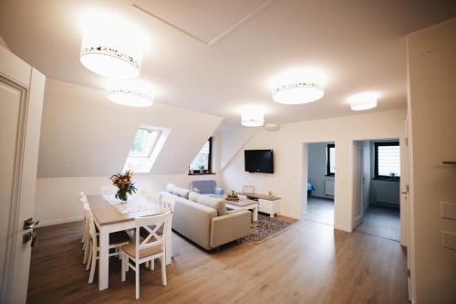 a living room with a couch and a table at Gościniec Kaszubski Las, Ruda 3 in Bartoszylas