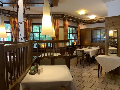 a restaurant with two tables and a balcony at Gasthaus Beinker in Ostercappeln