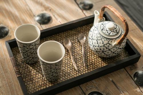 a tray with three cups and utensils on a table at Quentin Prague Hotel in Prague