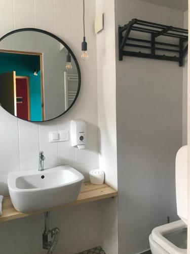 a bathroom with a white sink and a mirror at Vardeni Guesthouse in Hrazdan