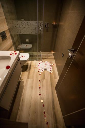 a bathroom with a heart made out of candy canes on the floor at SBN Suite Hôtel in Tangier