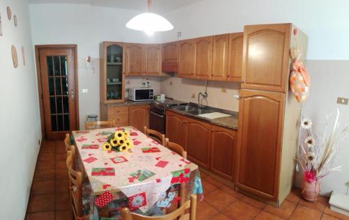 a kitchen with a table with a christmas table cloth at A Casa Mia in Cascina