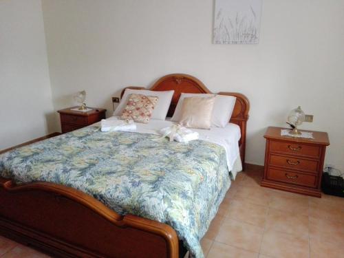 a bedroom with a bed with two night stands and two lamps at A Casa Mia in Cascina