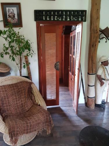 a room with a chair and an open door at En pleine nature in Bonneuil-en-Valois