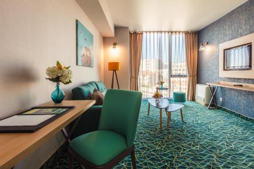 a hotel room with a desk and a room at Marina Burgas Hotel in Burgas City