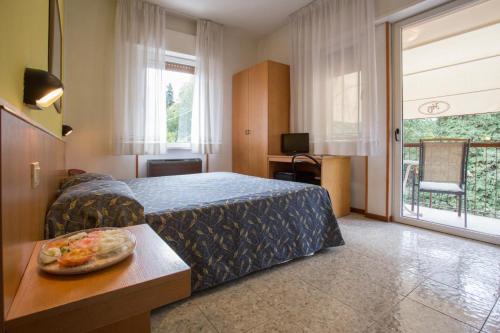 Postel nebo postele na pokoji v ubytování Hotel Benacus