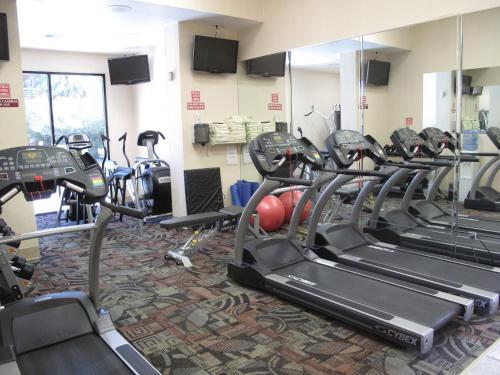 a gym with rows of treadmills and exercise bikes at Wyndham El Paso Airport and Water Park in El Paso