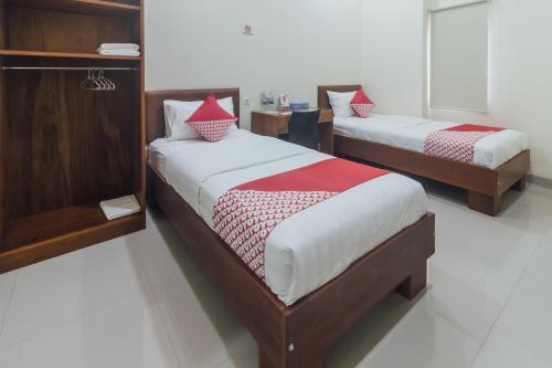Ένα ή περισσότερα κρεβάτια σε δωμάτιο στο Clean & Comfort Homestay