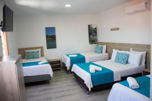 Postel nebo postele na pokoji v ubytování Hotel Aldea Plaza