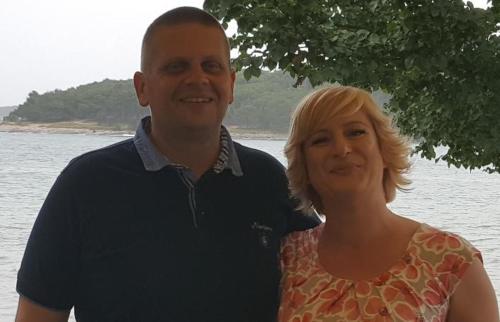 a man and a woman standing next to the water at Apartment Stanko in Ližnjan